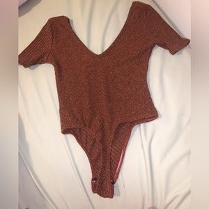 (4) PrettyLittleThing Rib-Knit Dirt Orange bodysuit